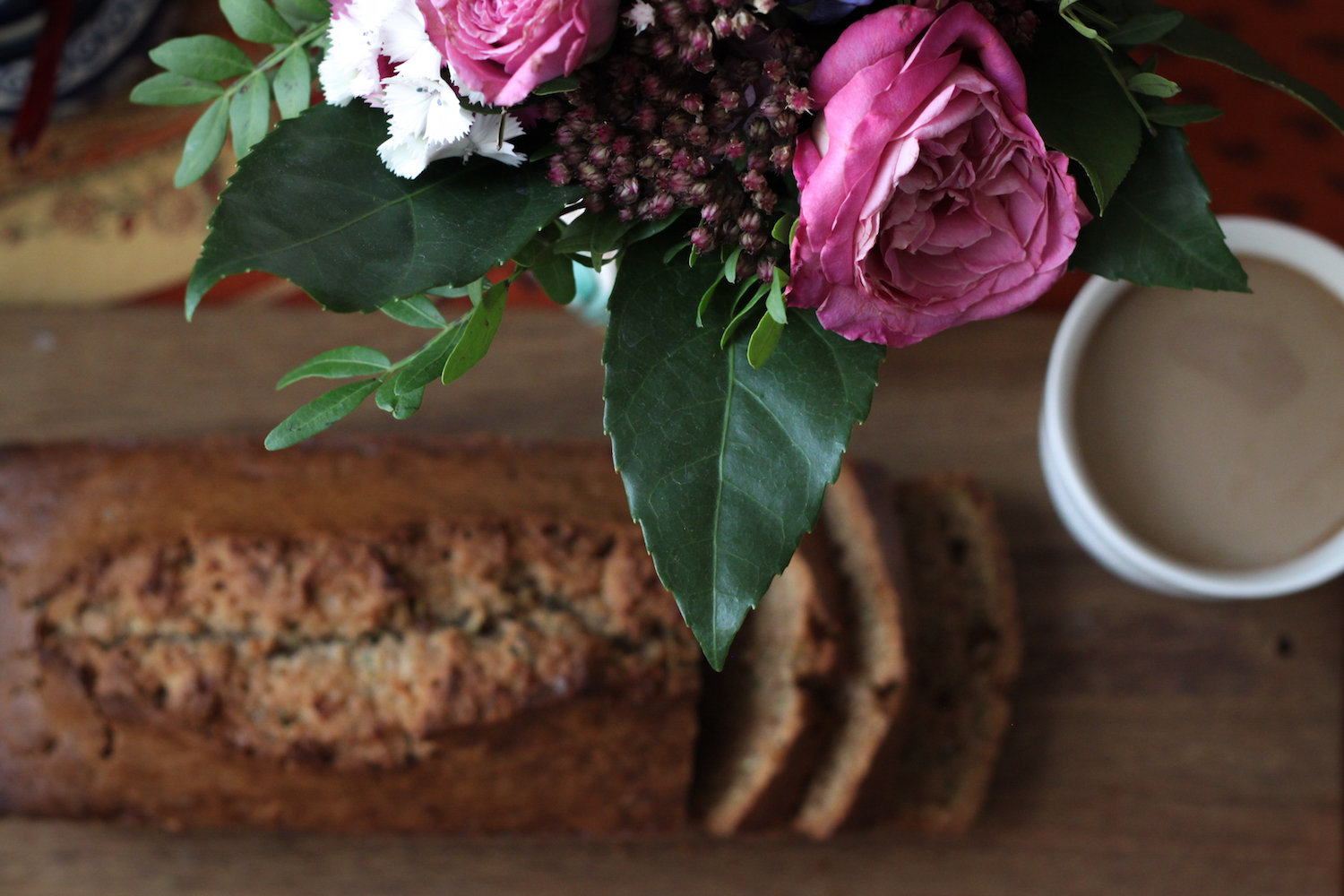 Still life with zucchini bread, flowers, and coffee (Eat Me. Drink Me.)